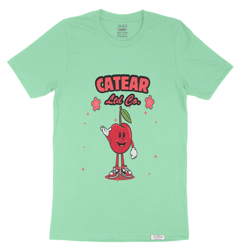 Unisex Mint color tee with hand-drawn cherry mascot screen printed on the front, woven label on bottom left 100% Cotton. Relaxed fit & great feel.